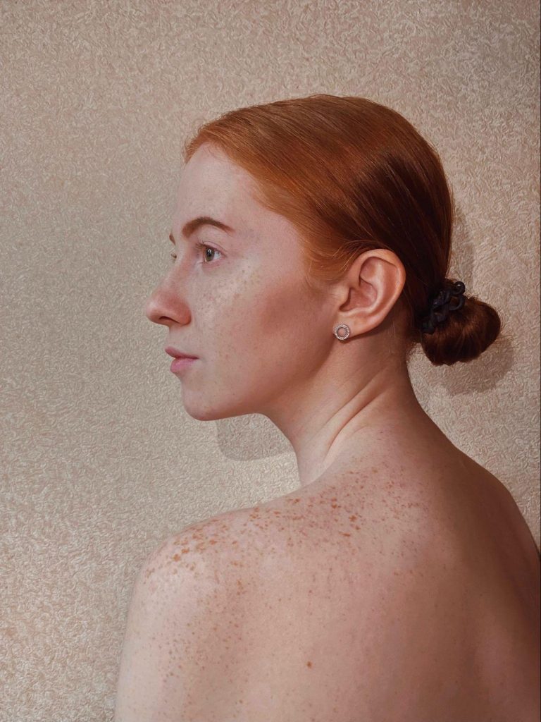 Redheaded woman with slicked-back bun