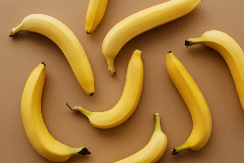Yellow bananas laid out on caramel-colored surface